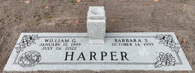 companion gray granite headstone with firefighter and gardenia emblems